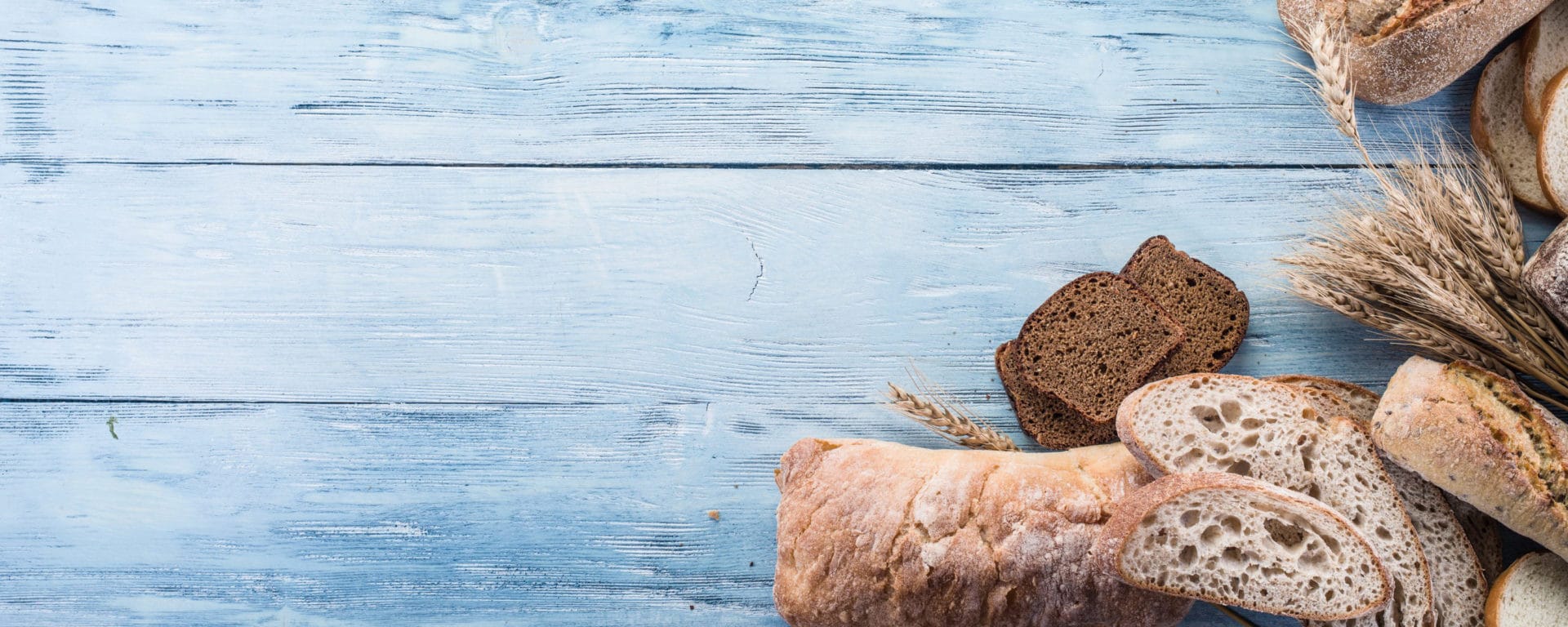 The bread and a wheat on the wooden desk.